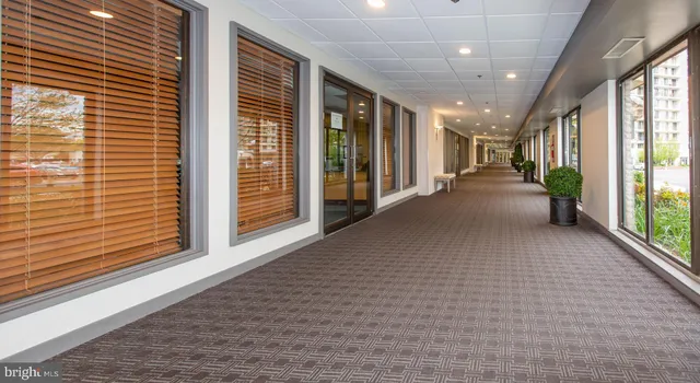a lobby with furniture and floor to ceiling window