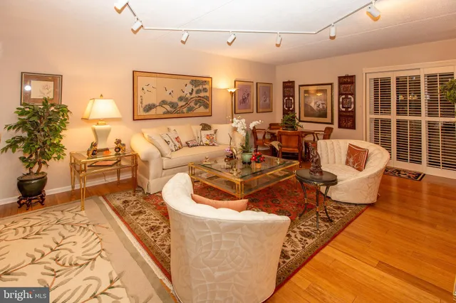 a living room with furniture and large windows