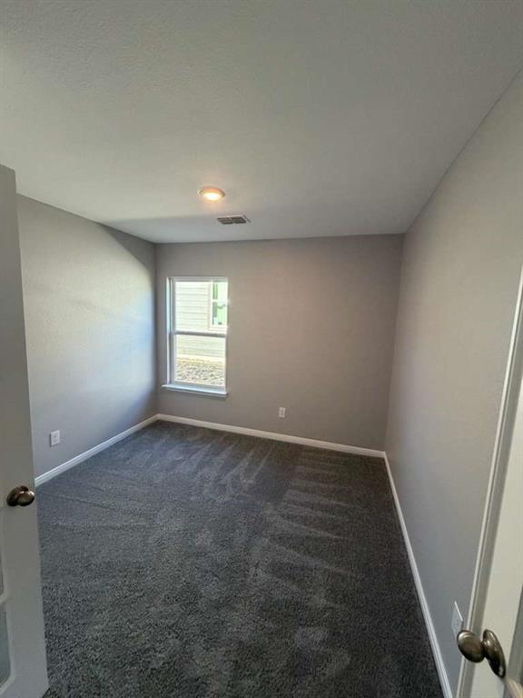 8008 Ravalli Street Ponder, TX 76259 - Photo 8 of 12 an empty room with windows