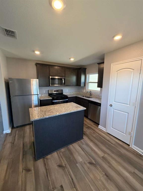 8008 Ravalli Street Ponder, TX 76259 - Photo 9 of 12 a large kitchen with stainless steel appliances granite countertop a stove and a refrigerator