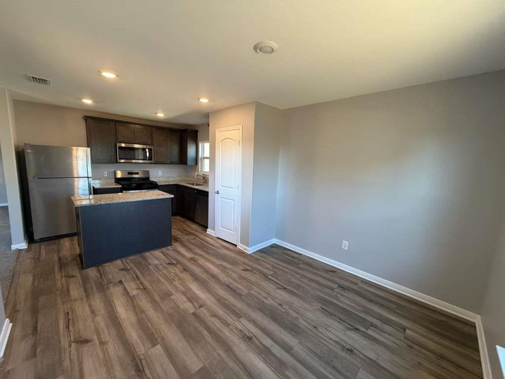 8008 Ravalli Street Ponder, TX 76259 - Photo 10 of 12 a kitchen with stainless steel appliances a refrigerator and a microwave