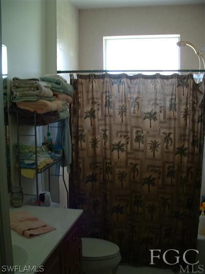 8632 Stringfellow Road St. James City, FL 33956 - Photo 2 of 10 a bathroom with a sink and a mirror