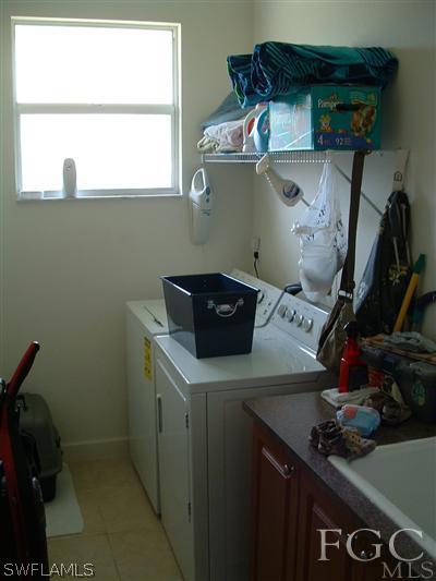 8632 Stringfellow Road St. James City, FL 33956 - Photo 3 of 10 a kitchen with a sink and cabinets