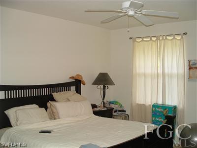 8632 Stringfellow Road St. James City, FL 33956 - Photo 6 of 10 a bedroom with furniture and a window