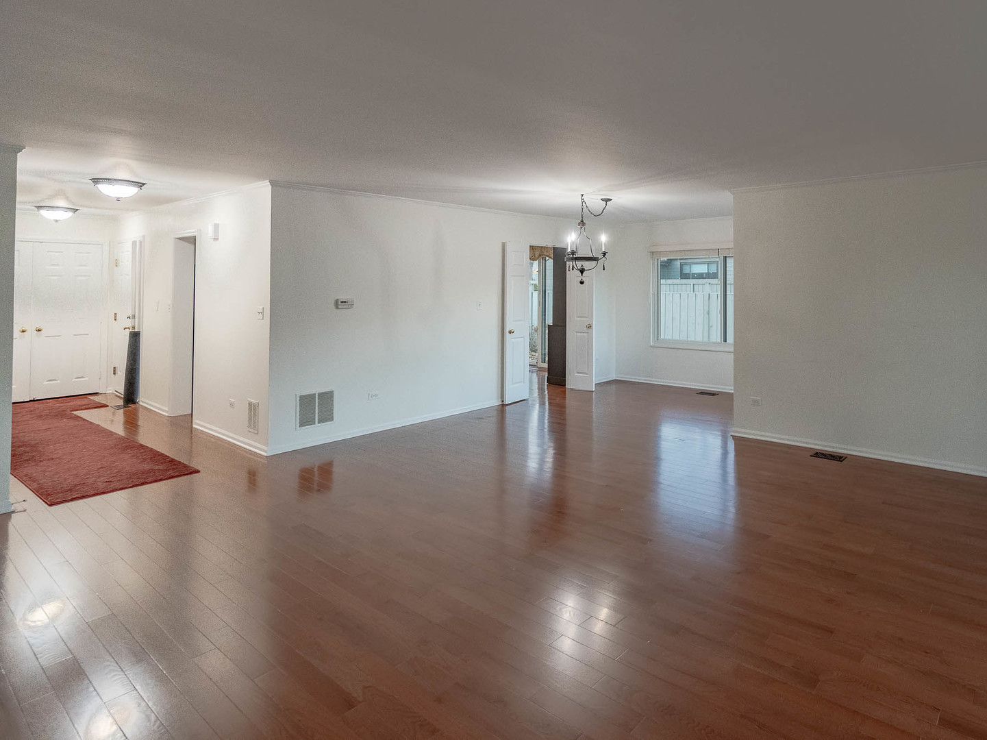 245 Timber Ridge Lane, Unit 245 Lake Barrington, IL 60010 - Photo 2 of 16 a view of an empty room with wooden floor and a window