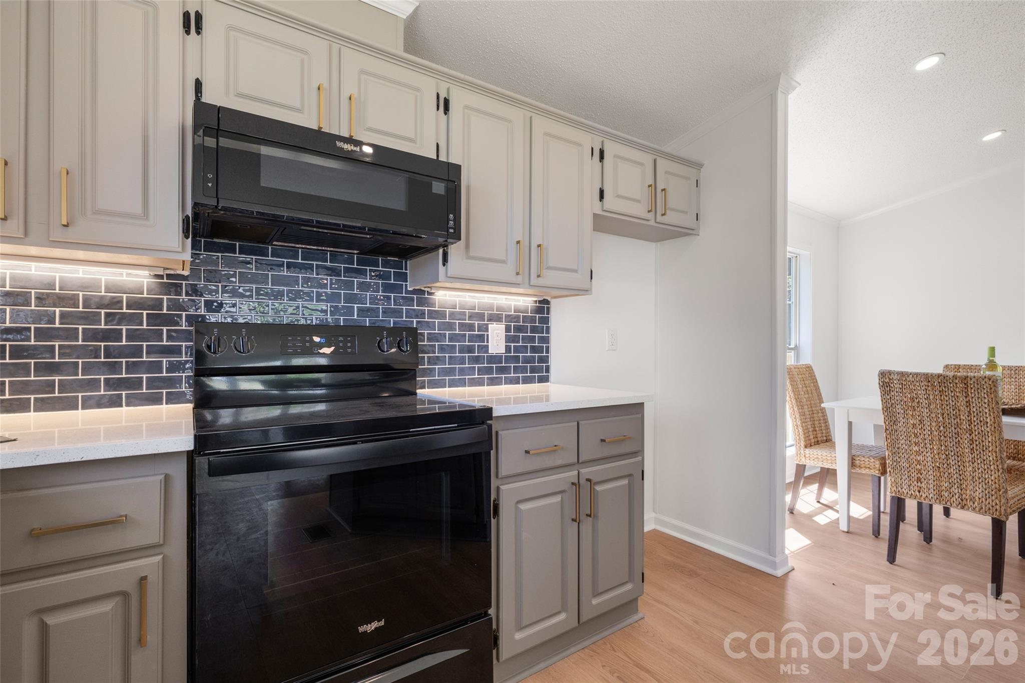 161 Baxter Way Forest City, NC 28043 - Photo 15 of 31 a kitchen with cabinets stainless steel appliances and wooden floor