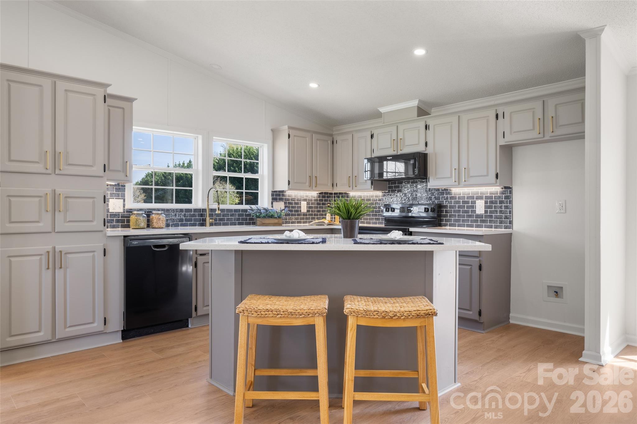 161 Baxter Way Forest City, NC 28043 - Photo 2 of 31 a kitchen with granite countertop white cabinets and stainless steel appliances