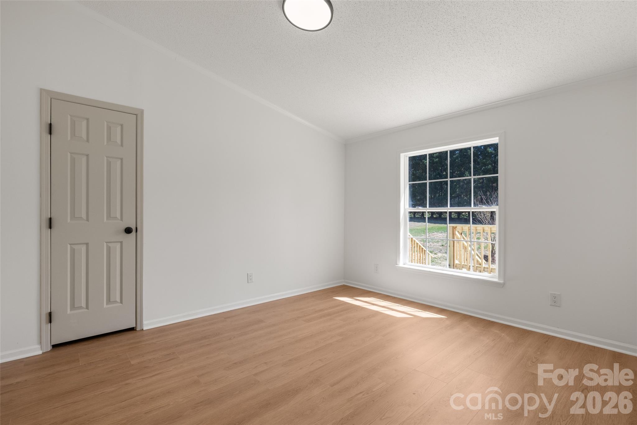 161 Baxter Way Forest City, NC 28043 - Photo 22 of 31 an empty room with wooden floor and windows