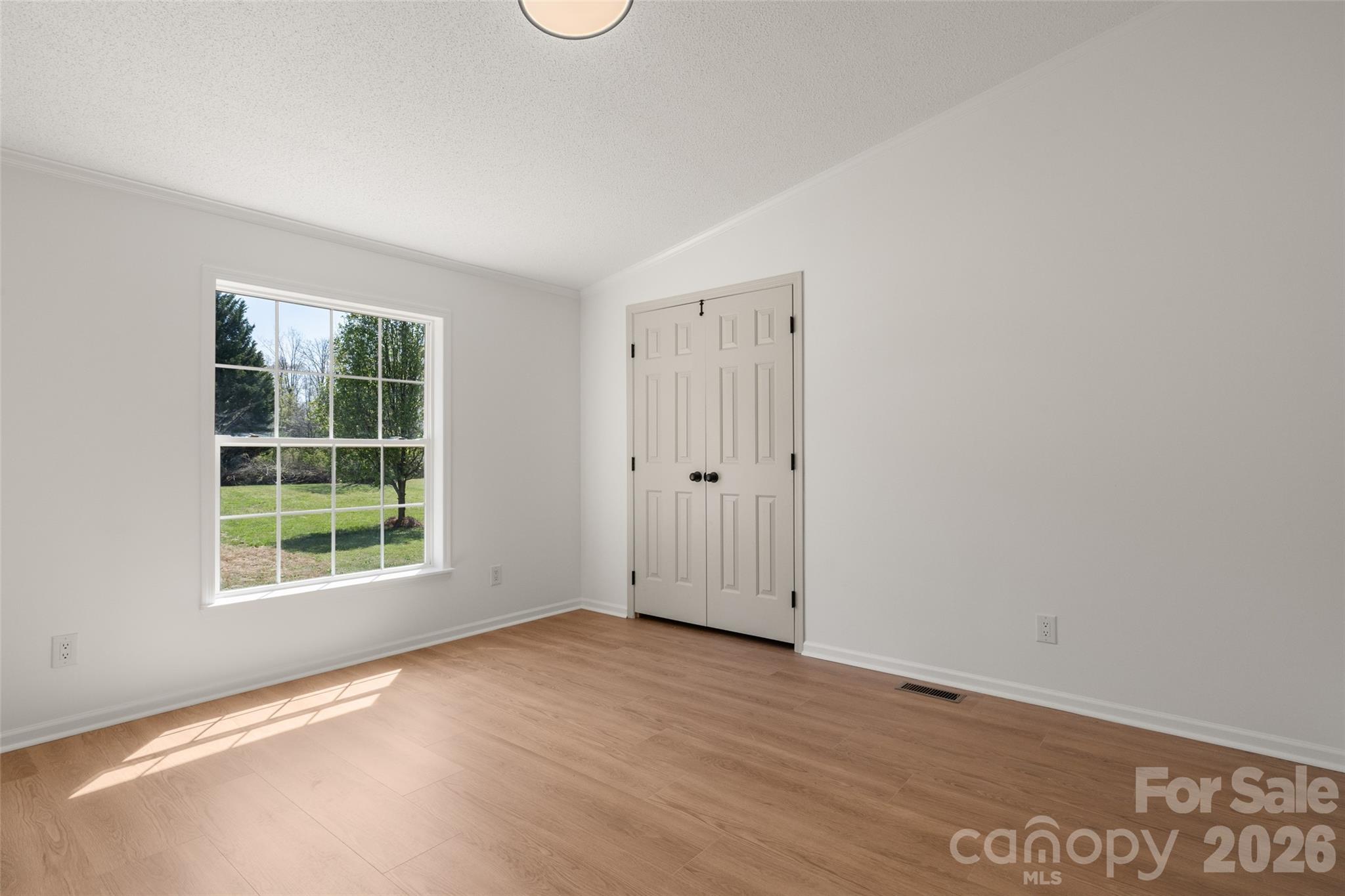 161 Baxter Way Forest City, NC 28043 - Photo 23 of 31 an empty room with wooden floor and windows
