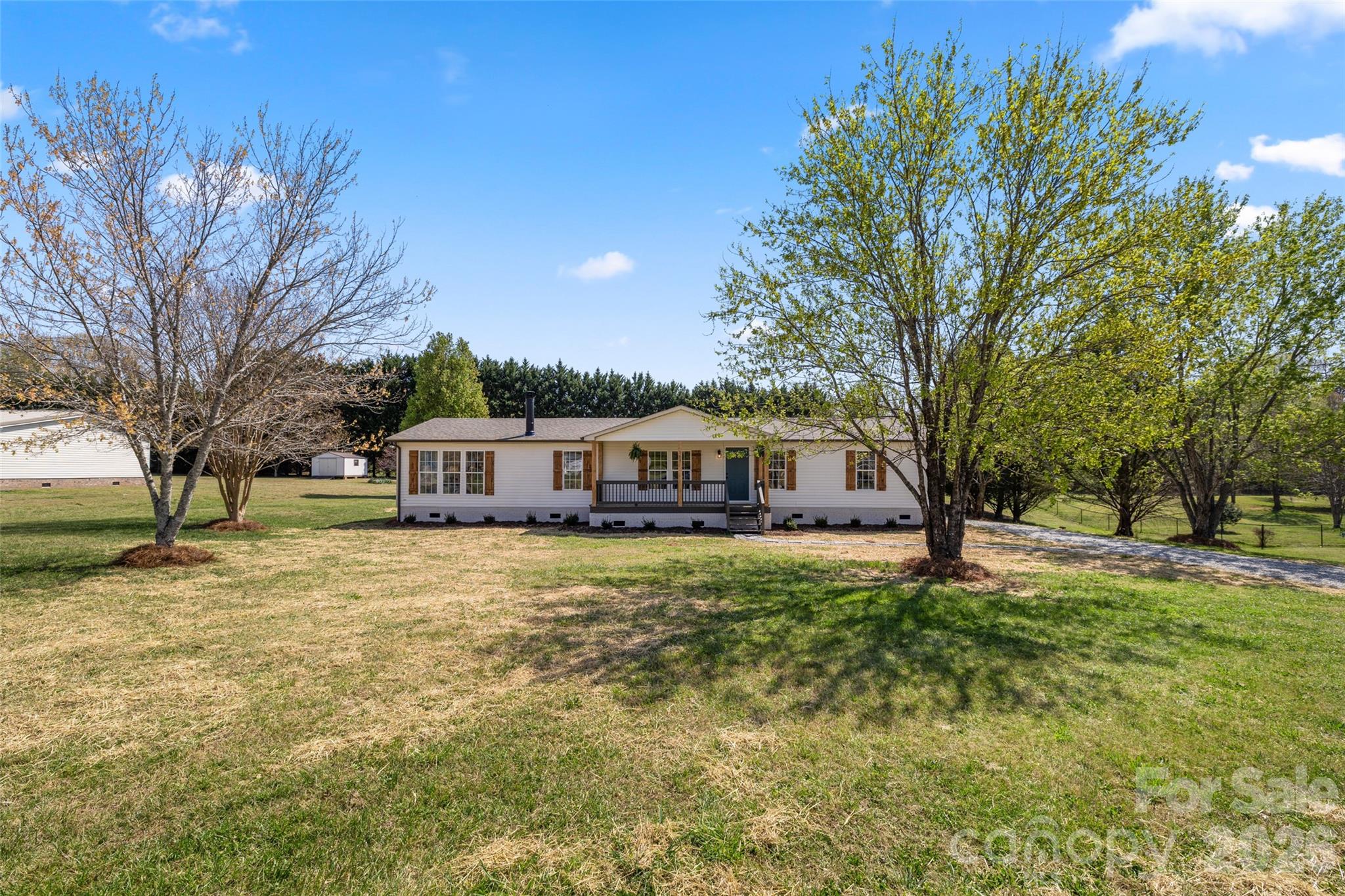 161 Baxter Way Forest City, NC 28043 - Photo 26 of 31 a front view of a house with a garden and trees