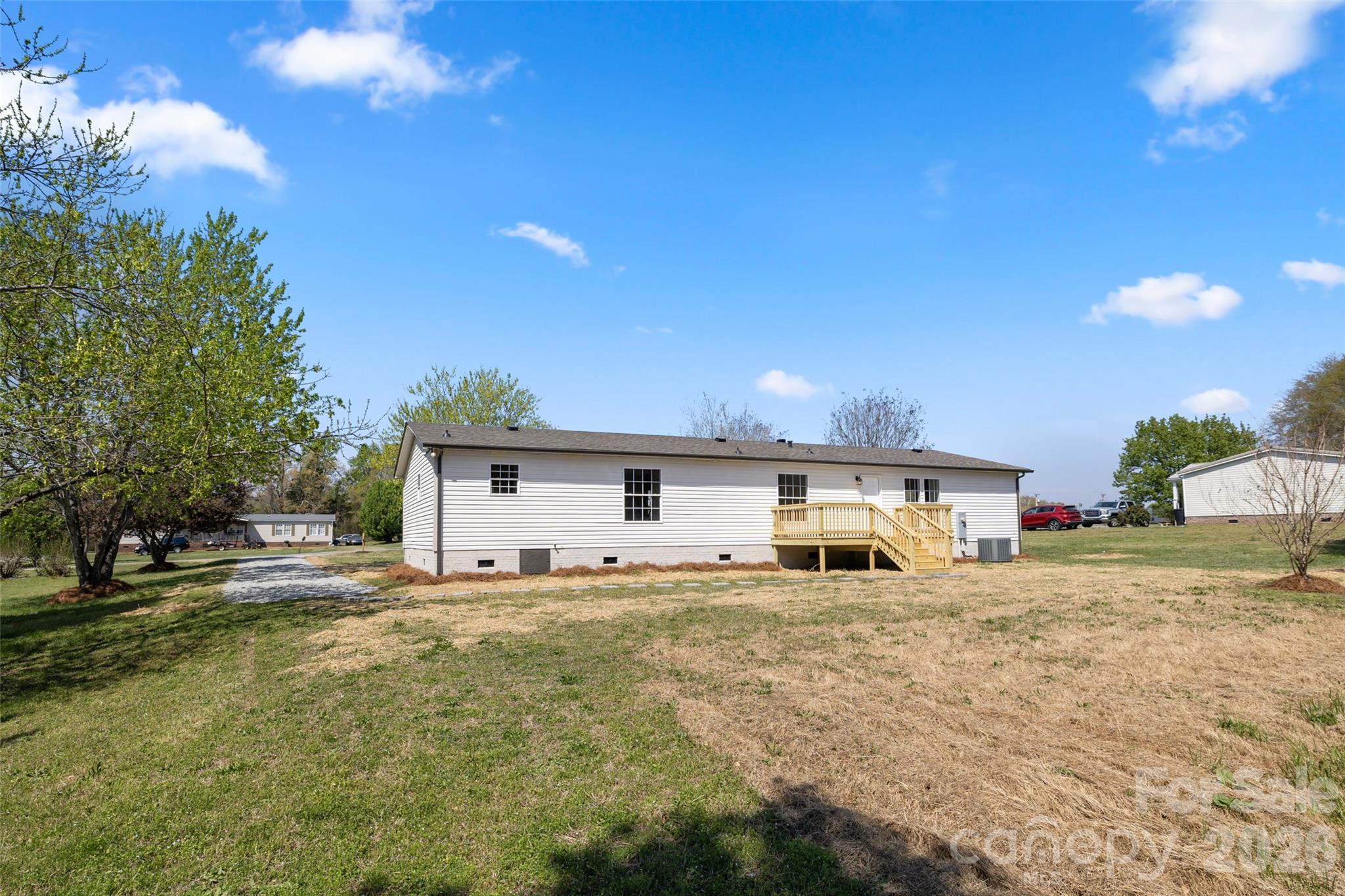 161 Baxter Way Forest City, NC 28043 - Photo 6 of 31 a large house with a big yard and large trees
