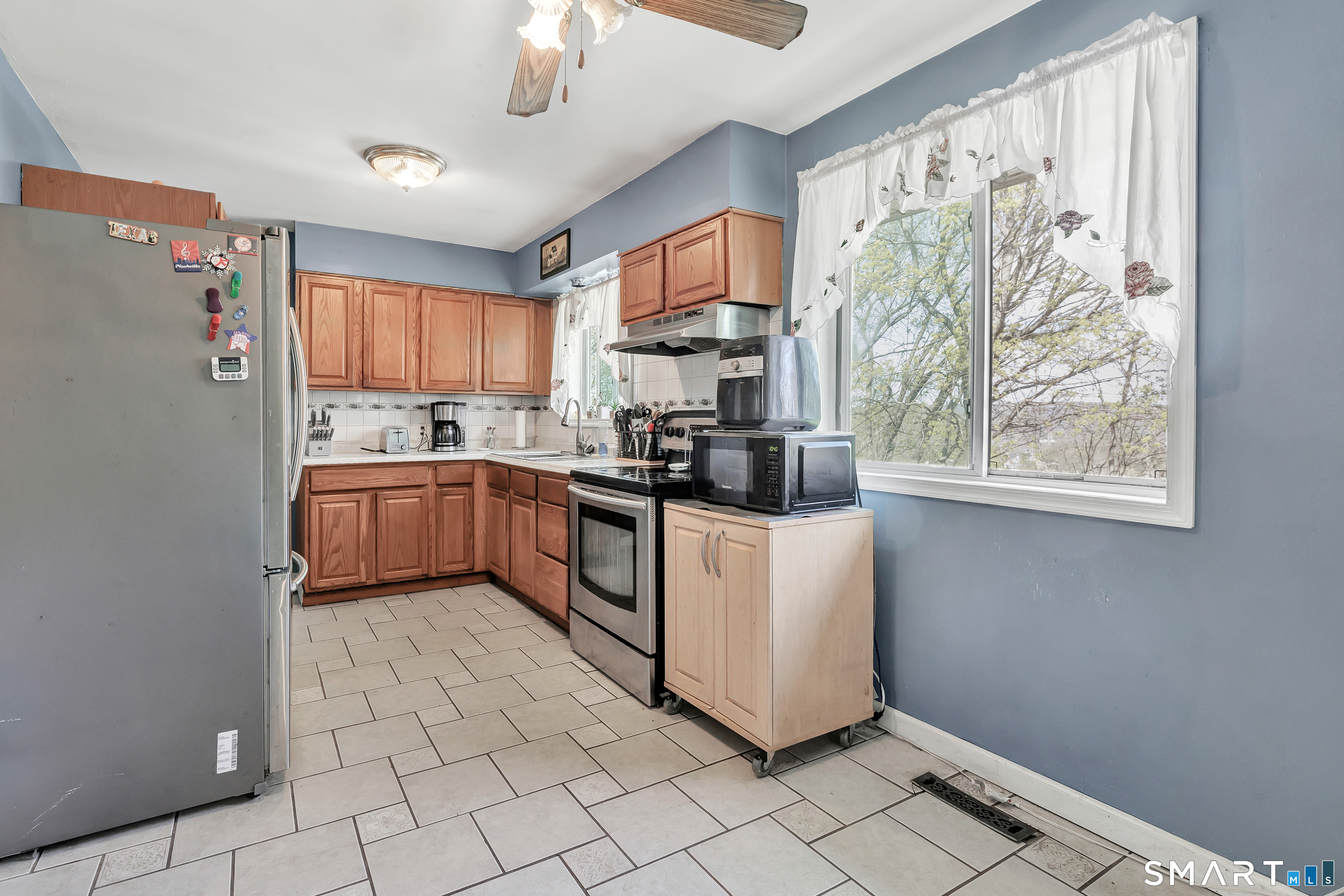 9 Alan Drive Ansonia, CT 06401 - Photo 11 of 34 a kitchen with stainless steel appliances a stove a sink and a refrigerator