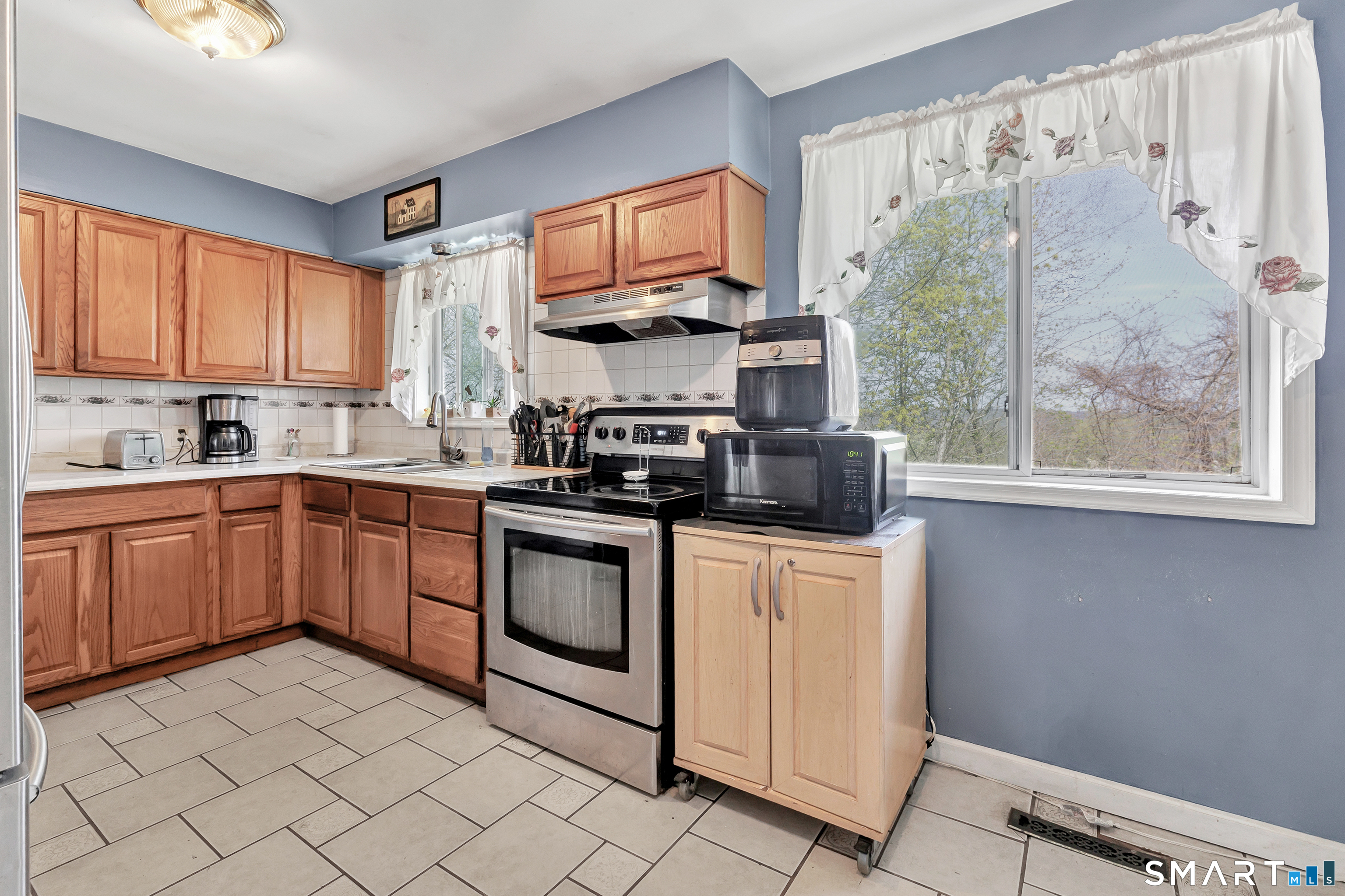 9 Alan Drive Ansonia, CT 06401 - Photo 12 of 34 a kitchen with stainless steel appliances granite countertop a stove a sink and a microwave