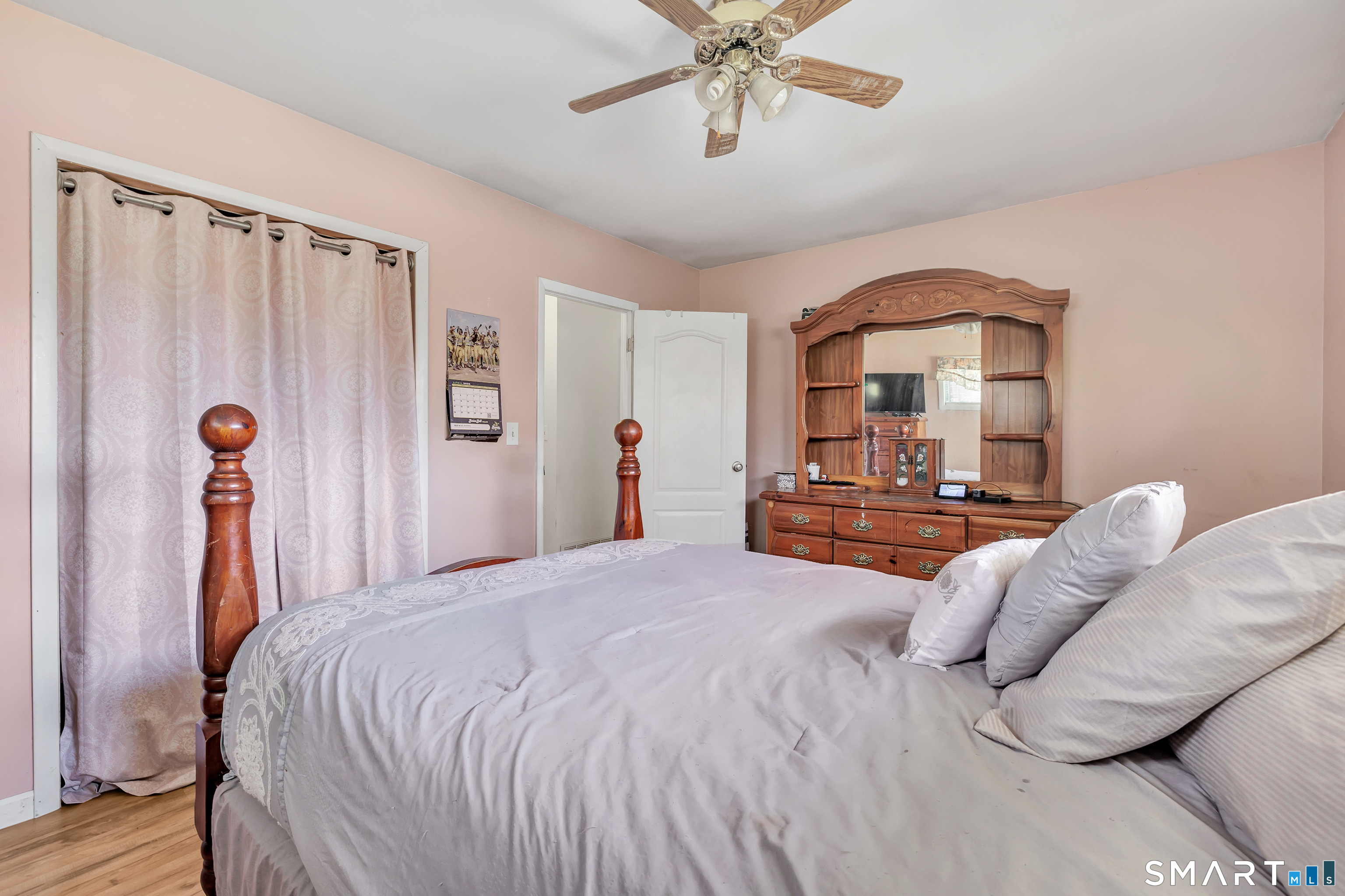 9 Alan Drive Ansonia, CT 06401 - Photo 22 of 34 a bedroom with a large bed and a chandelier