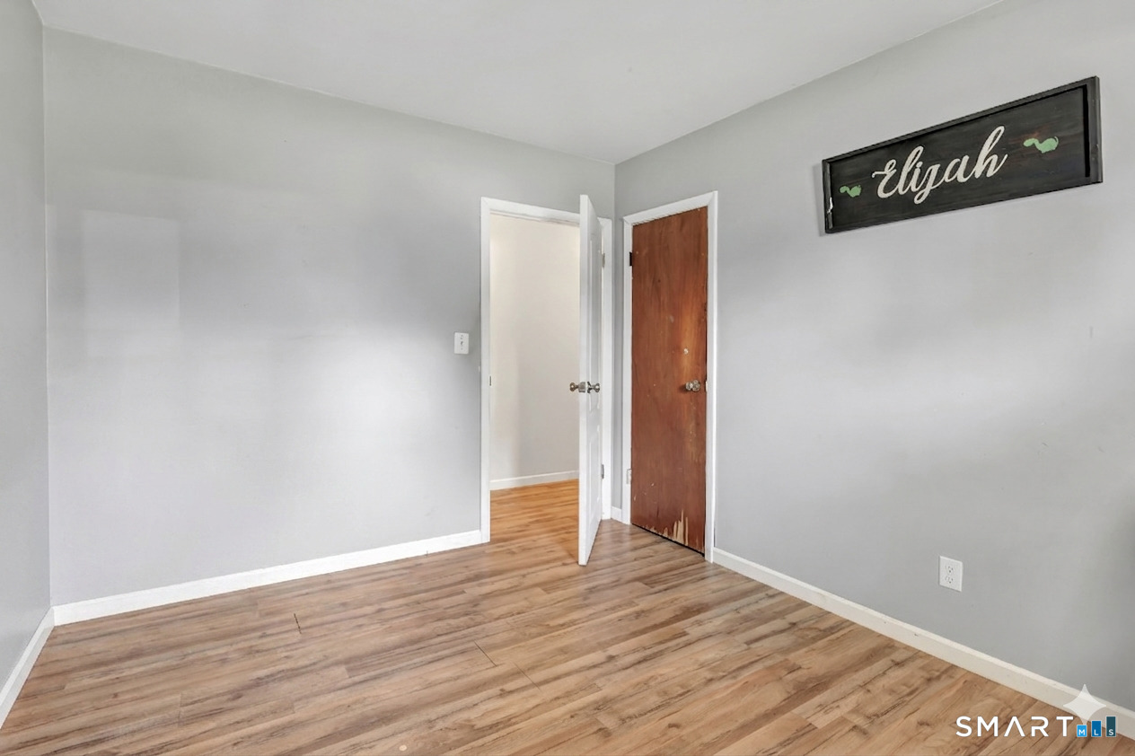 9 Alan Drive Ansonia, CT 06401 - Photo 26 of 34 a view of an empty room with wooden floor