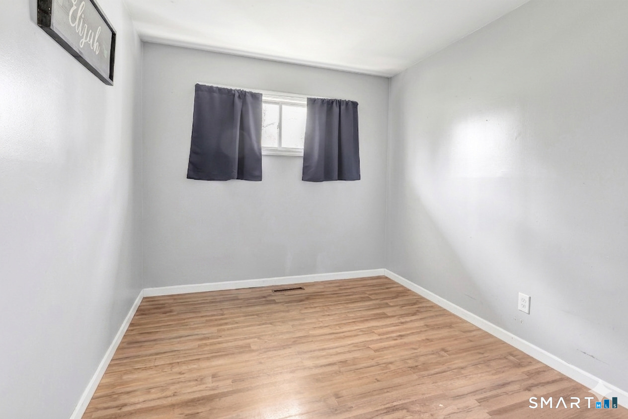 9 Alan Drive Ansonia, CT 06401 - Photo 27 of 34 a view of empty room with wooden floor and fan