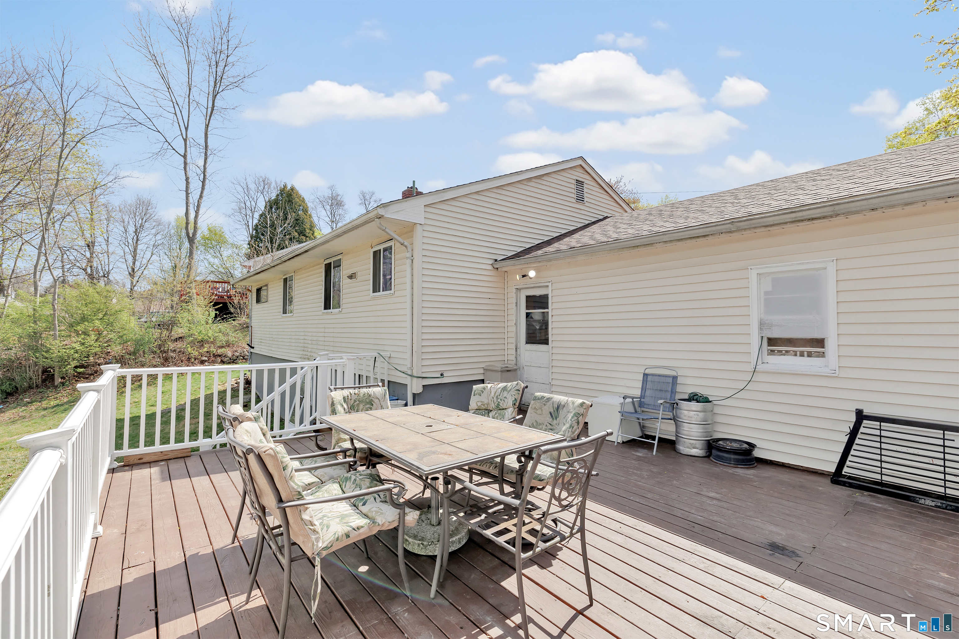 9 Alan Drive Ansonia, CT 06401 - Photo 31 of 34 a view of a patio with table and chairs with wooden floor and fence