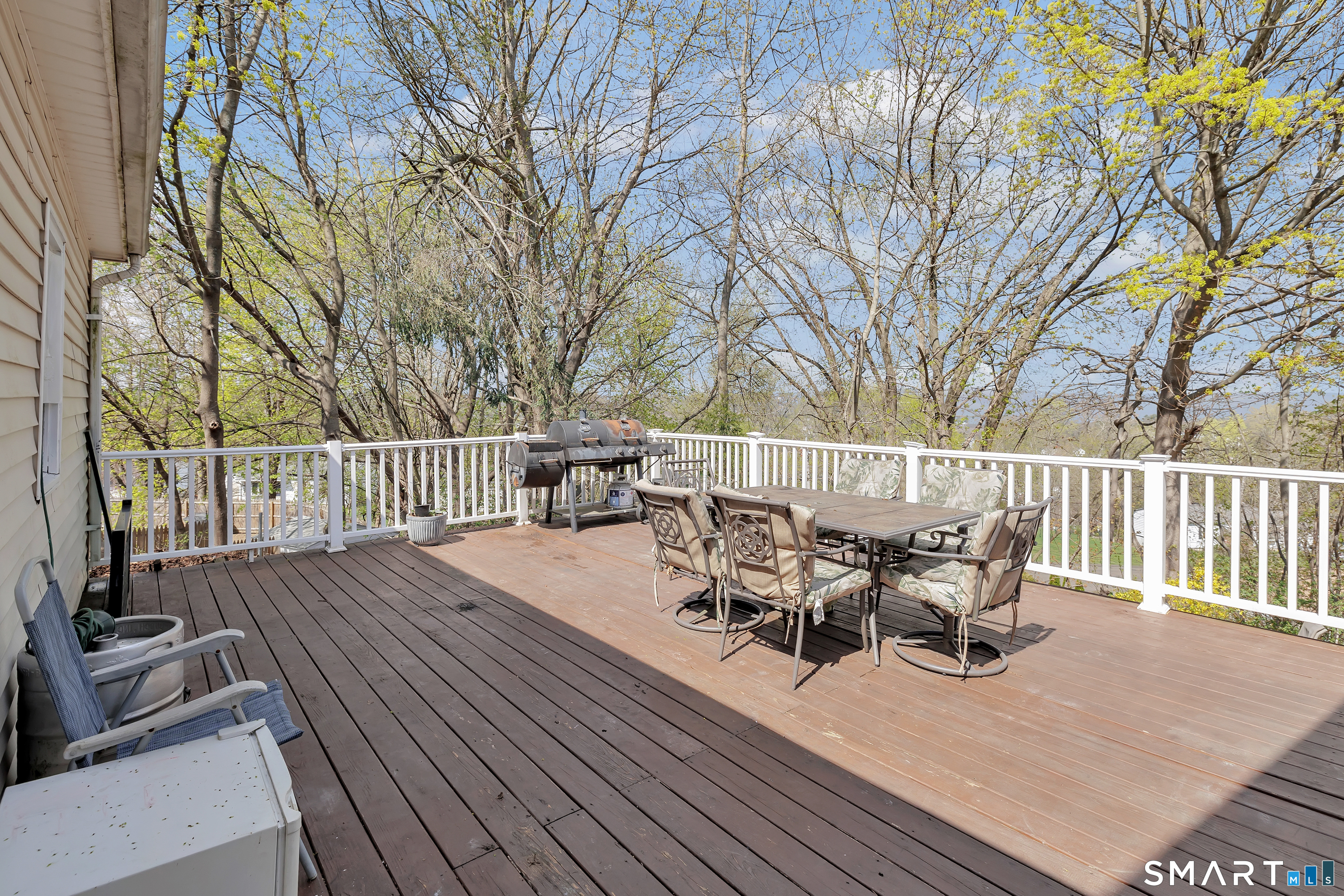 9 Alan Drive Ansonia, CT 06401 - Photo 32 of 34 a view of a roof deck with table and chairs and wooden floor