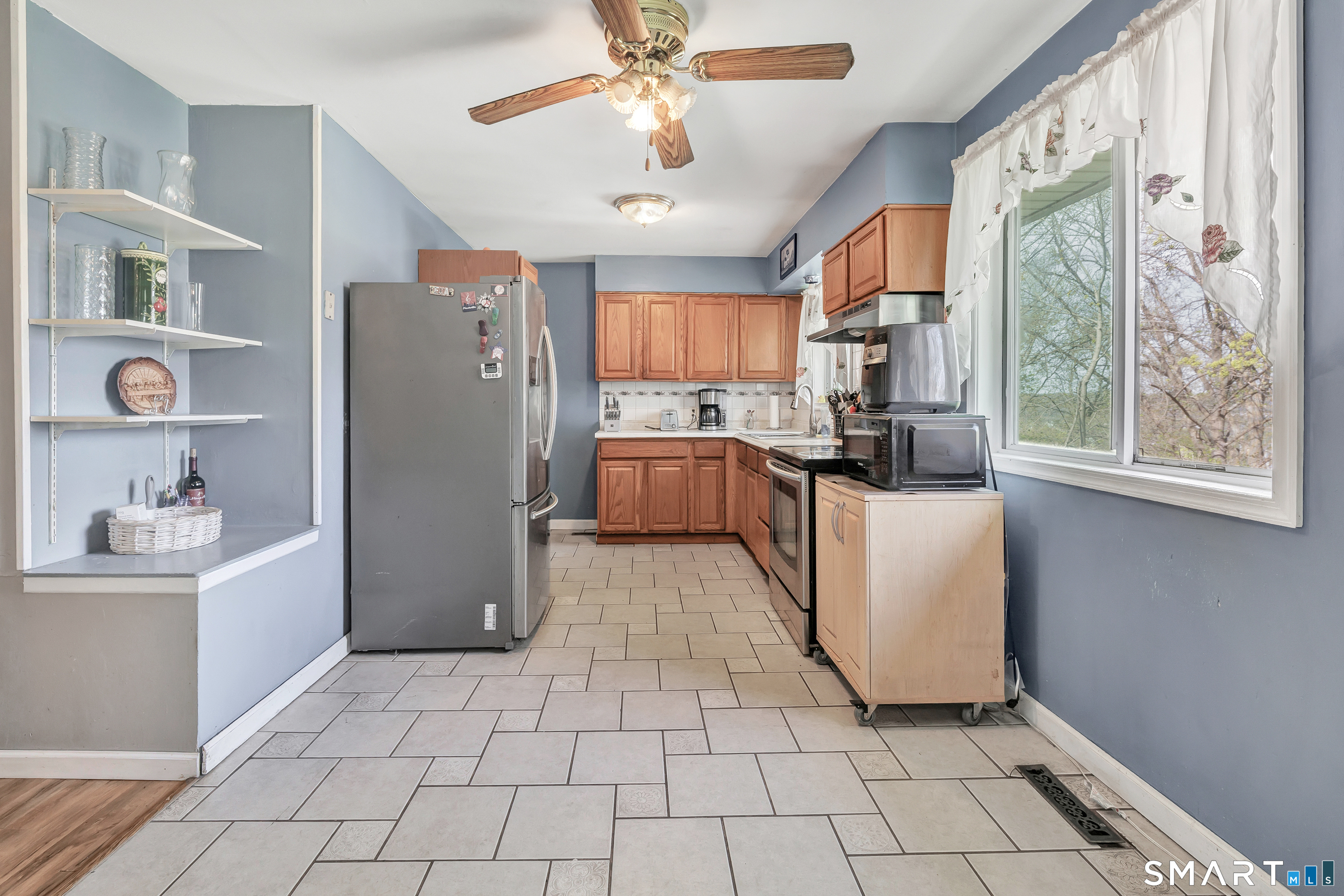 9 Alan Drive Ansonia, CT 06401 - Photo 10 of 34 a kitchen with refrigerator and window