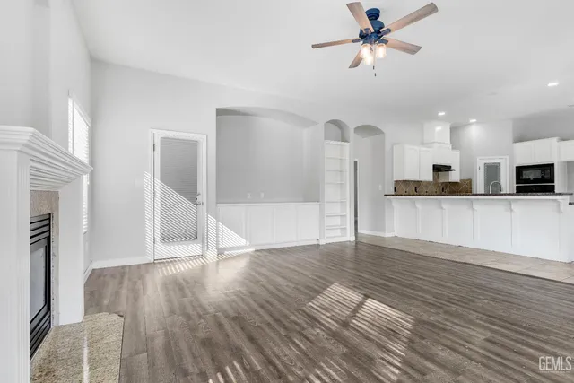 a view of a kitchen with wooden floor and a kitchen space