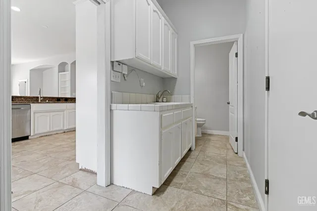 a kitchen with white cabinets and white appliances