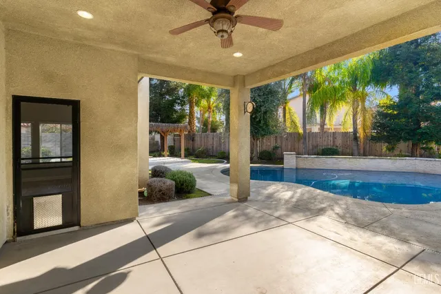 a bedroom with a large bed and a large window with outer view