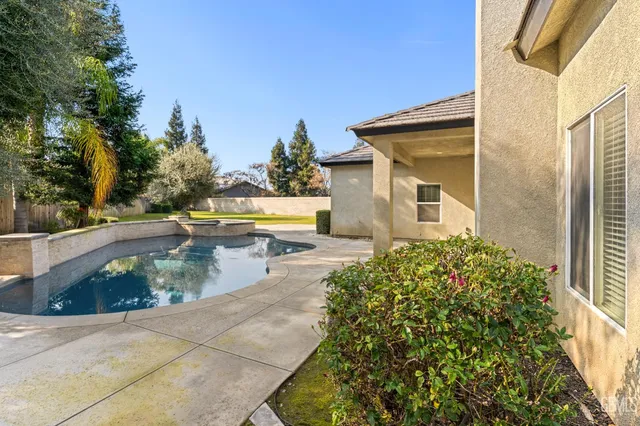 a view of a swimming pool with a patio
