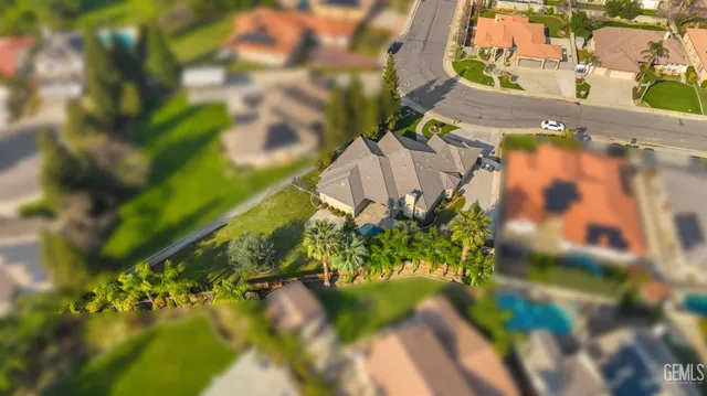 an aerial view of a house with a yard and garden