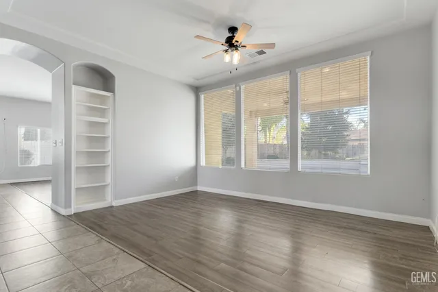 a view of wooden floor and windows in a room