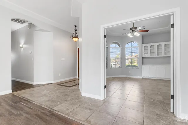 a view of a cabinet and a chandelier fan in a room