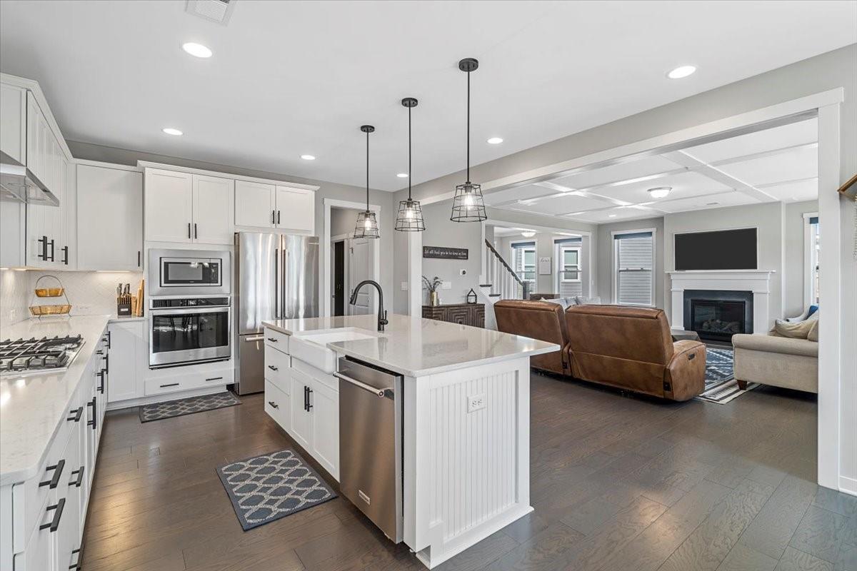 3728 Rustic Pne Way Clover, SC 29710 - Photo 12 of 48 a large white kitchen with a stove a sink a couch and a dining table