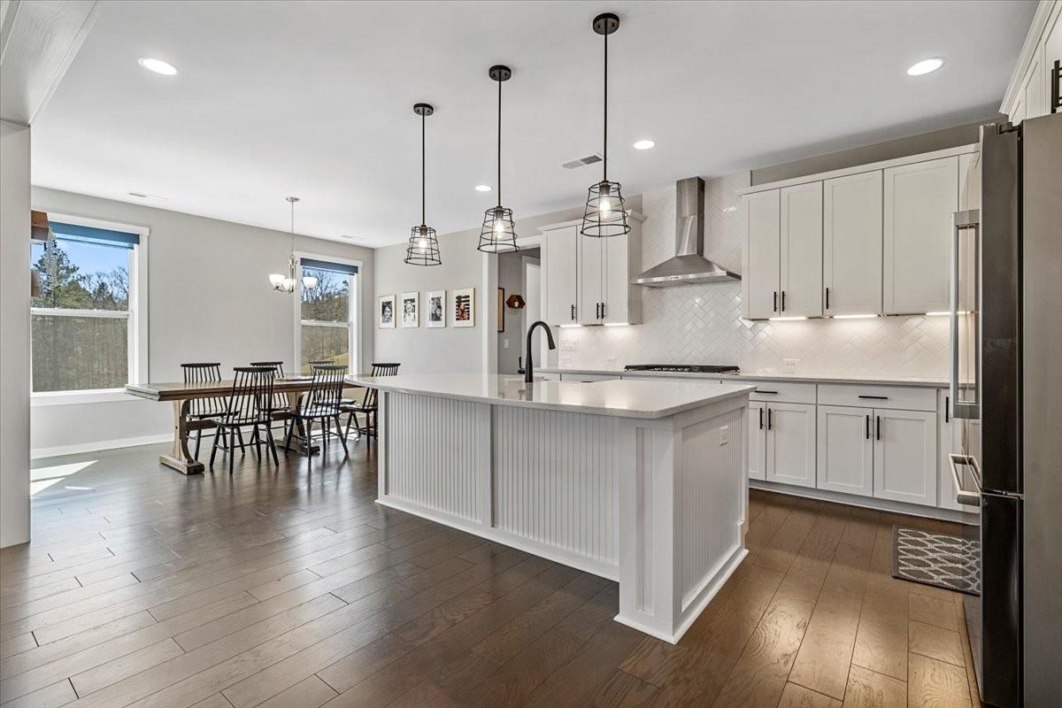 3728 Rustic Pne Way Clover, SC 29710 - Photo 8 of 48 a kitchen with stainless steel appliances kitchen island granite countertop a table chairs and a sink