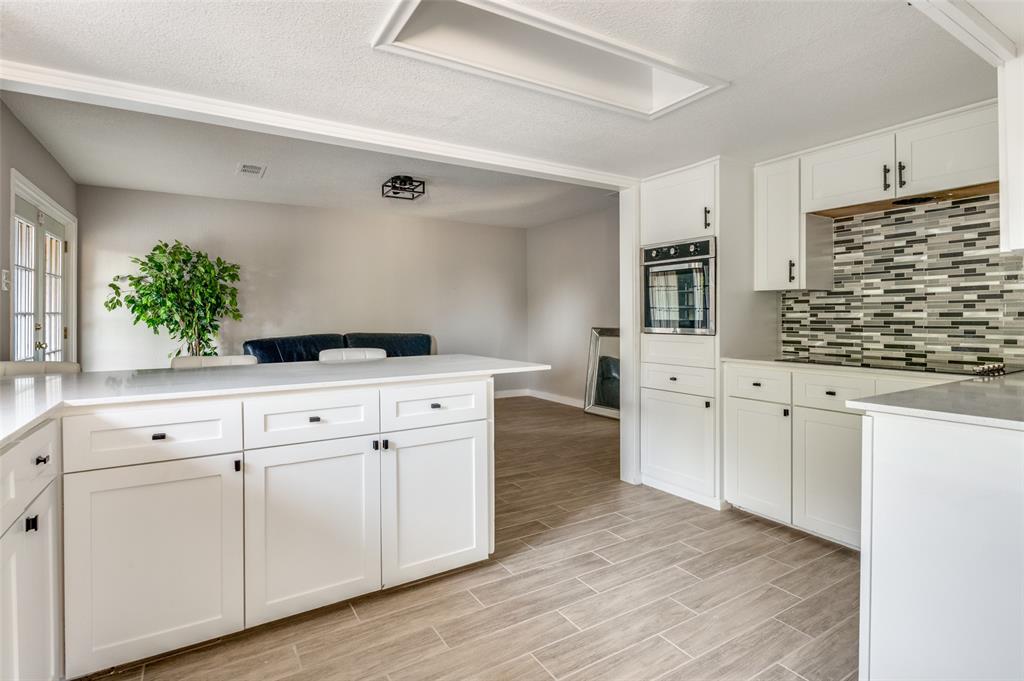 1287 Whispering Trail Dallas, TX 75241 - Photo 12 of 24 a kitchen with white cabinets and a stove