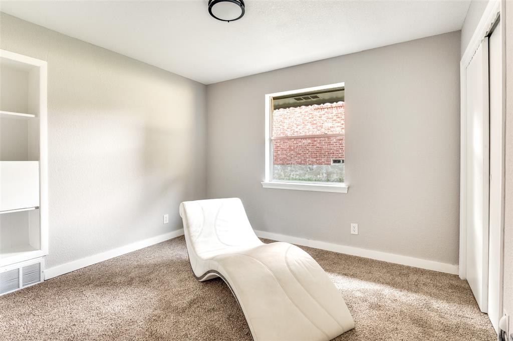 1287 Whispering Trail Dallas, TX 75241 - Photo 17 of 24 a bedroom with a bed and a window