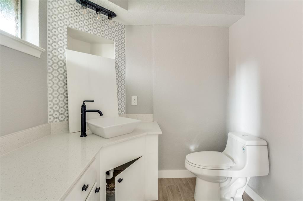 1287 Whispering Trail Dallas, TX 75241 - Photo 21 of 24 a bathroom with a sink a toilet and mirror