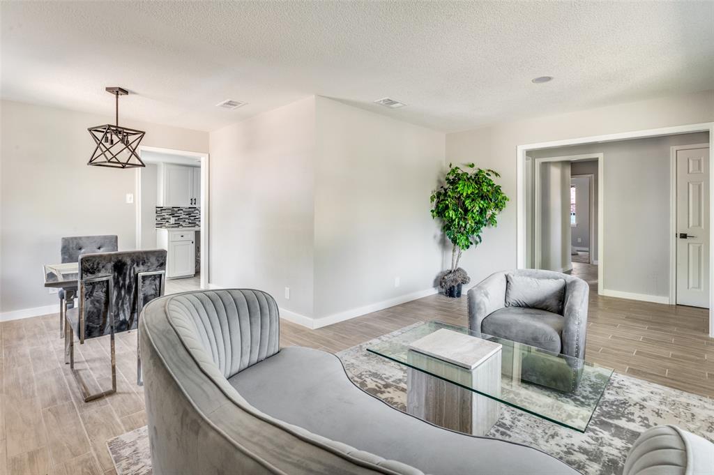1287 Whispering Trail Dallas, TX 75241 - Photo 7 of 24 a living room with furniture and wooden floor