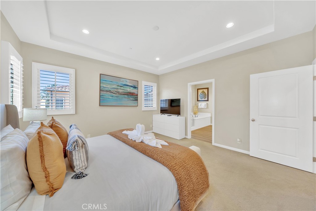 75 Gardenstone Path Irvine, CA 92620 - Photo 30 of 65 a bedroom with a bed and wooden floor