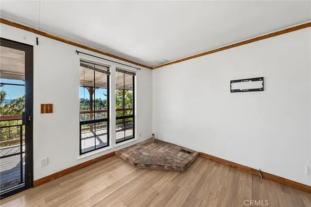 en empty room with sliding glass door and wooden floor