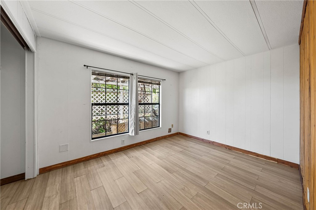 3360 Yuba Street Nice, CA 95464 - Photo 21 of 50 an empty room with wooden floor and windows