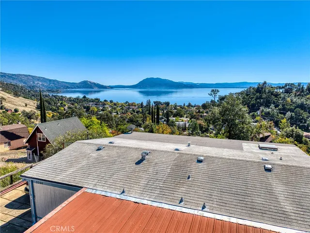 a view of a house with a yard and sitting area