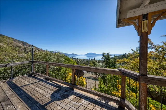 a view of balcony with wooden floor and fence