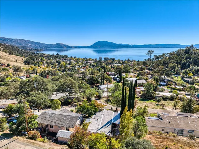 an aerial view of a house with yard swimming pool and mountain view in back