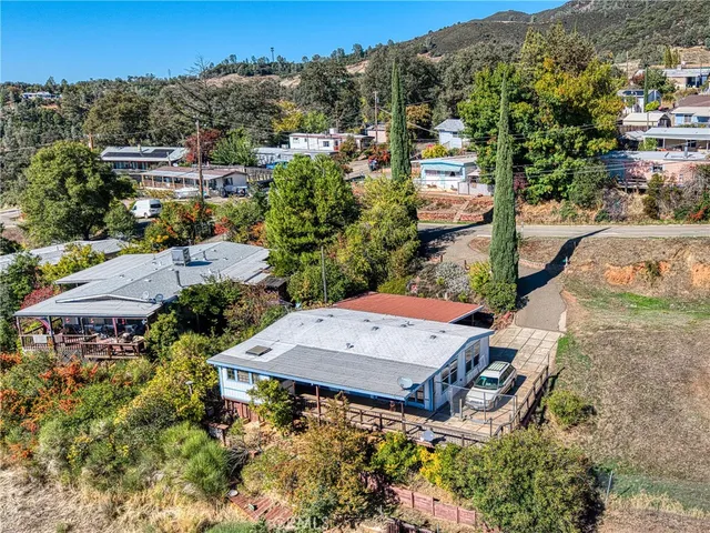 an aerial view of a house with a yard