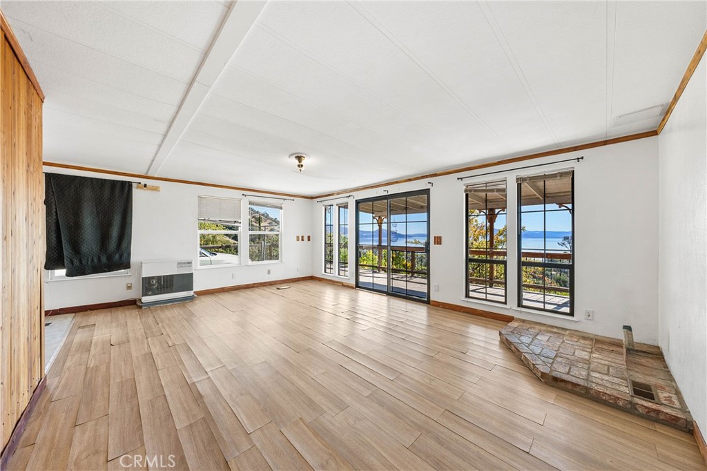 3360 Yuba Street Nice, CA 95464 - Photo 7 of 50 a view of an empty room with wooden floor and a window