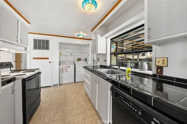 a kitchen with stainless steel appliances granite countertop a stove and a sink