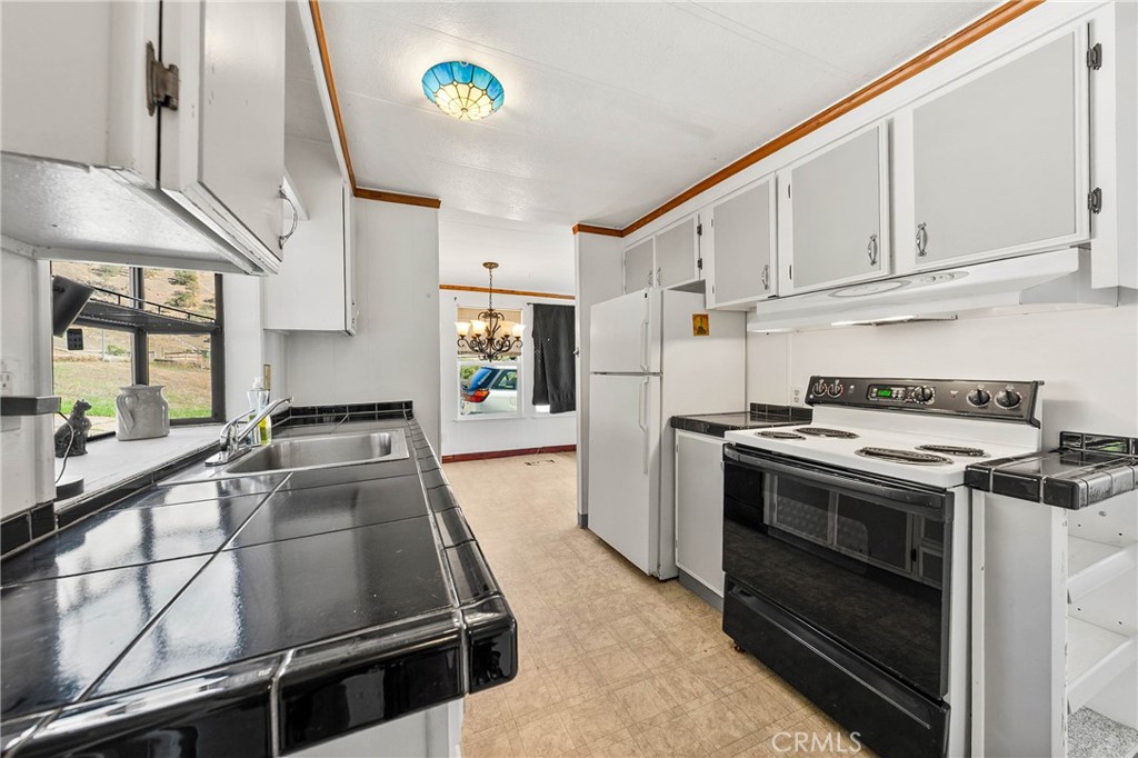 3360 Yuba Street Nice, CA 95464 - Photo 9 of 50 a kitchen with stainless steel appliances granite countertop a stove and a sink