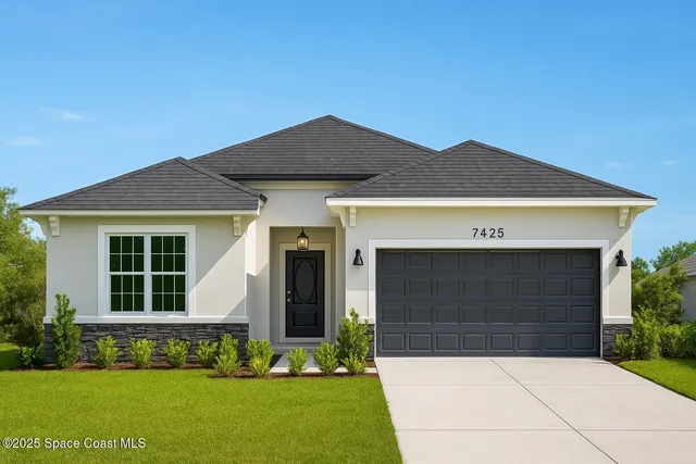 a front view of a house with a garden and yard