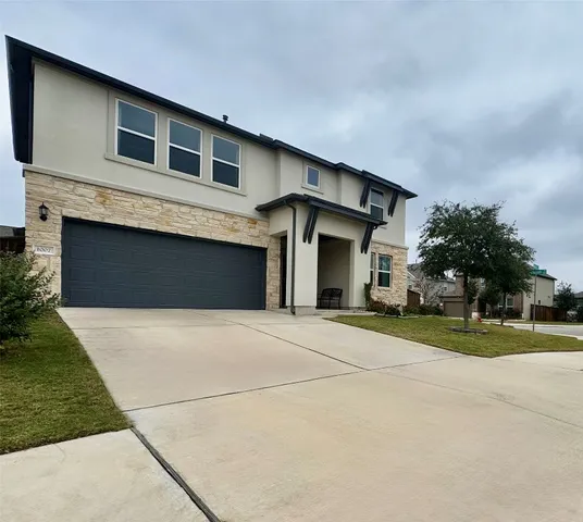a front view of a house with a yard and garage