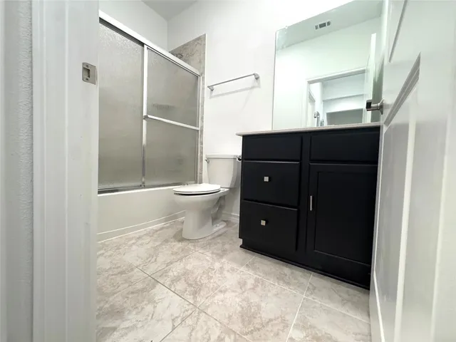 a bathroom with a toilet a sink and shower