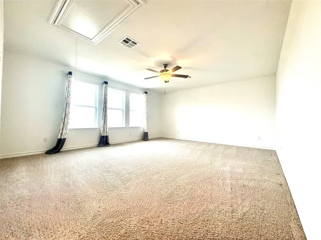 an empty room with a window and fireplace
